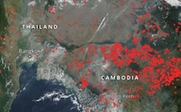 This screen capture from NASA Worldview shows the locations of widespread thermal anomalies and smoke haze in Thailand and neighboring Cambodia.