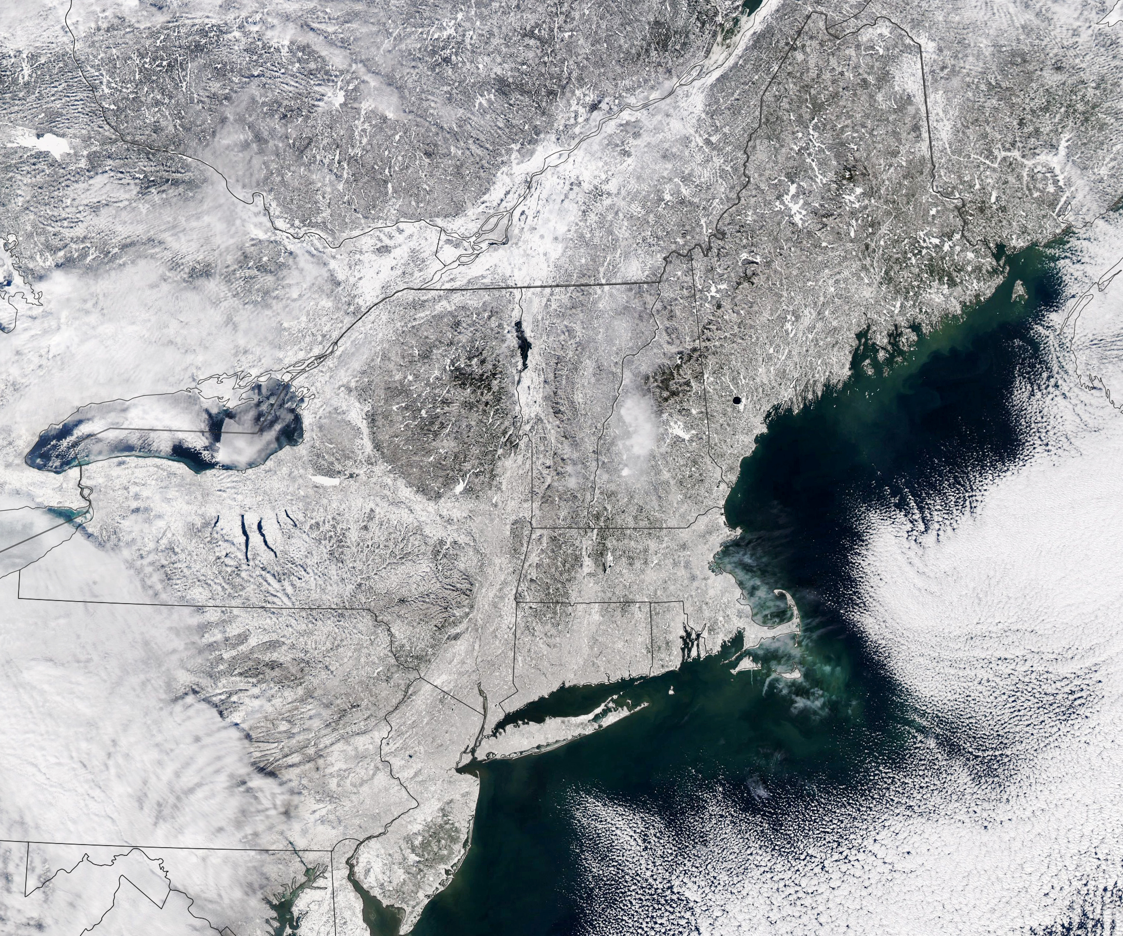 A true-color satellite image showing the northeastern and mid-Atlantic states covered in snow following a January 2022 storm.