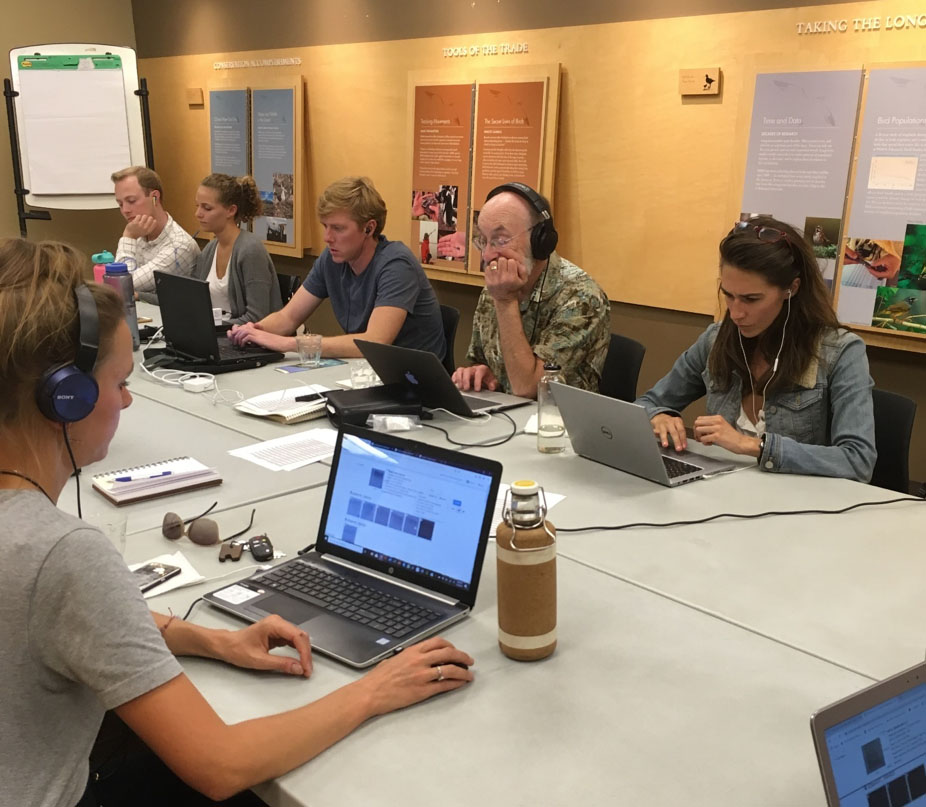 Photo of citizen scientists at laptops gathered to work on a