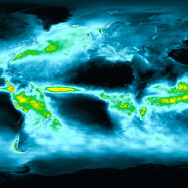 This a rectangular graphic of the world. It has a black background with the continents outlined in shades of blue. Bands of clouds and rain are visible near the equator. The rainy areas are shaded green to indicate light precipitation intensity, then yellow to red to show where rainfall is heavier to heaviest. 