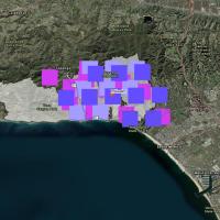 This rectangular image shows the location of satellite-based fire detection targets overlaid on visible imagery of the Los Angeles area landscape. In the center of the image over Pacific Palisades, CA, are nearly 30 pink, light purple, and purple squares showing the location of suspected fires.