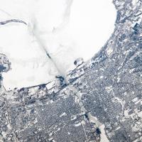 Taken from the International Space Station (ISS), this photograph shows the city of Green Bay, Wisconsin, at the southern end of icebound Green Bay, a basin of Lake Michigan. The heavy snowfalls of winter 2014 cover the landscape. 