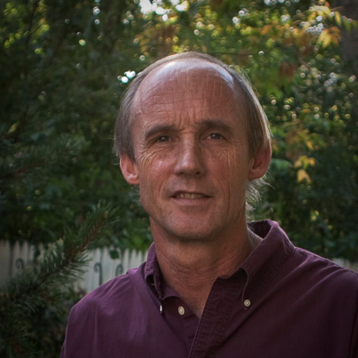 Headshot of kummerow sitting outside wearing a red polo shirt