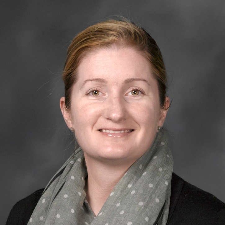 Headshot of gina henderson wearing a gray scarf inside