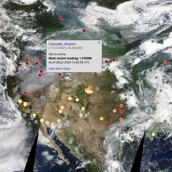 true-color satellite image of western U.S. with colored dots indicating AERONET sites; gray banner in center of image indicated selected site