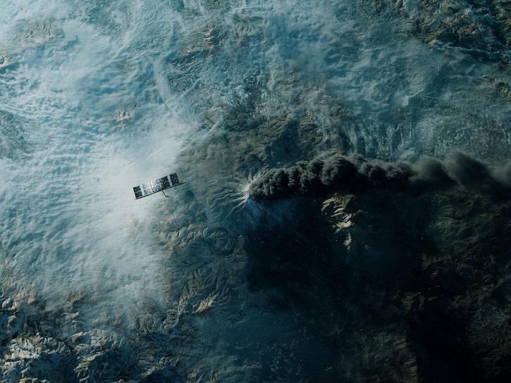 ICEYE satellite in orbit over an erupting volcano.
