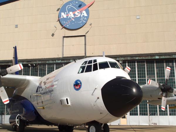 Image of the NASA/NSF C-130 aircraft on the ramp at the hangar