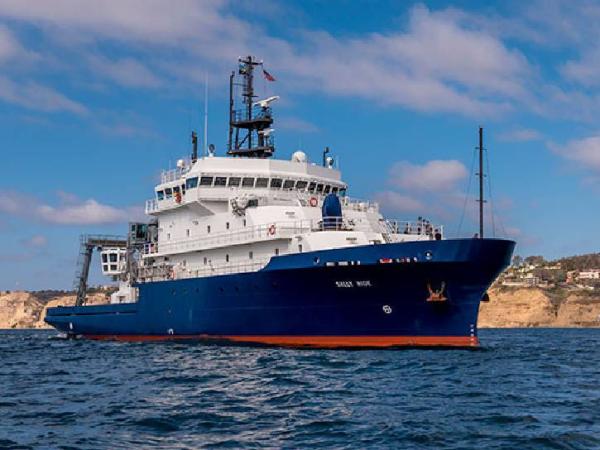 Image of the Research Vessel Sally Ride from the NASA PISTON campaign. The ship is red on the bottom, blue in the middle, and white on the top with several instruments on the ship