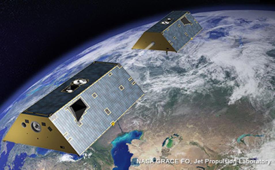 This artist illustration shows a pair of Gravity Recovery and Climate Experiment Follow-on (GRACE-FO) satellites in space over the Earth.