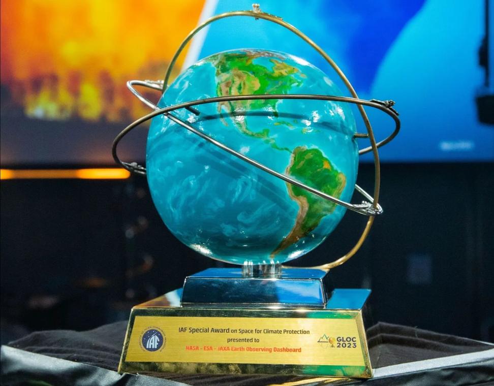 The IAF Special Award on Space for Climate Protection is a blue and green ceramic globe encircled with gold vectors