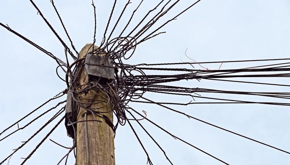 Electrical pole crowded with wires