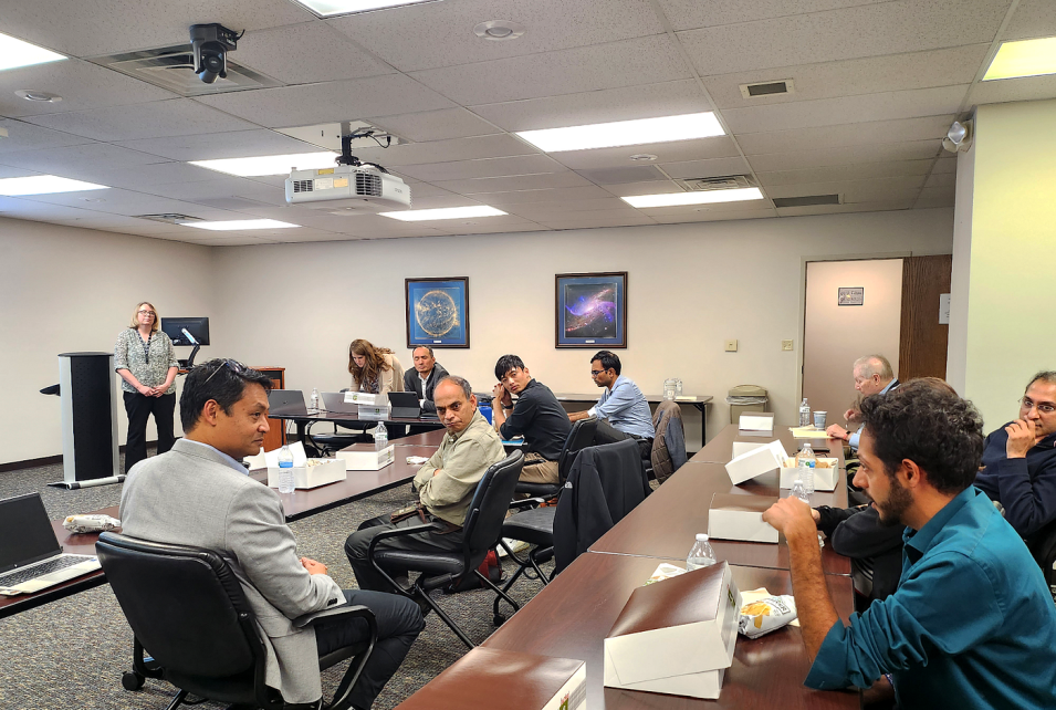 Discussion participants sit around a large conference table