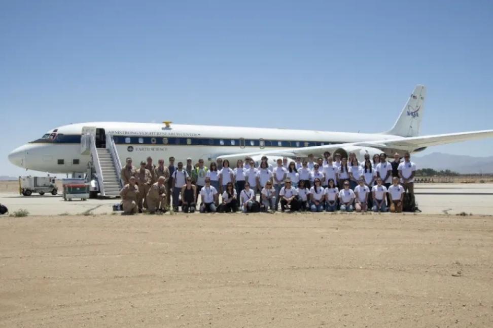 Students in the SARP Class of 2022 stand in front of the NASA DC-8 aircraft in an open airstrip