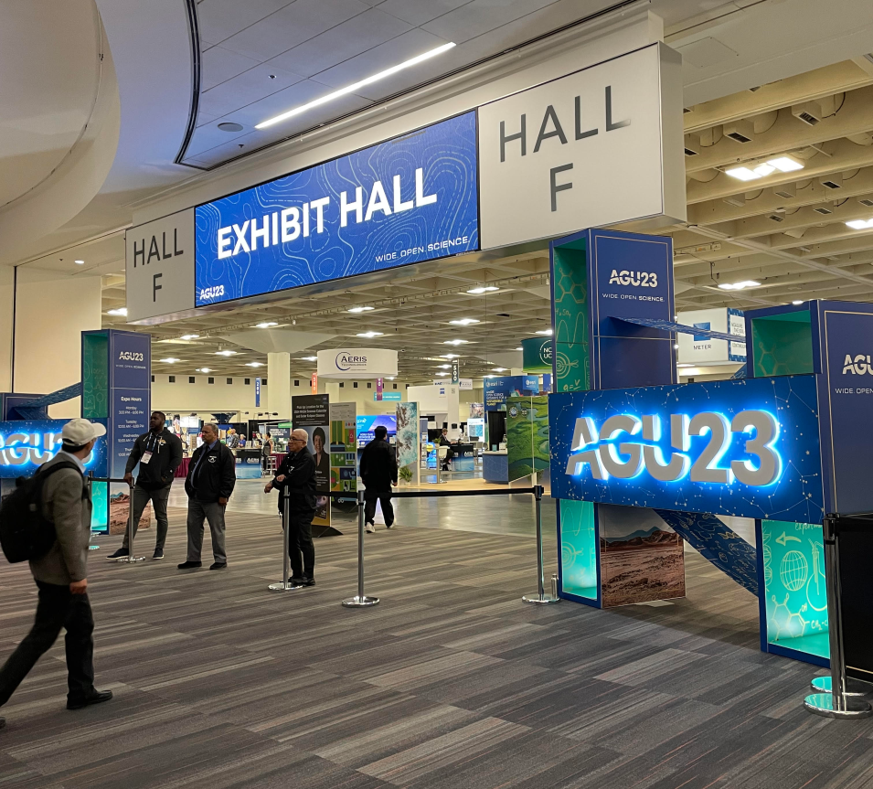 entrance to AGU Exhibit Hall, with blue sign AGU 23 on right and banner Exhibit Hall Hall F at top