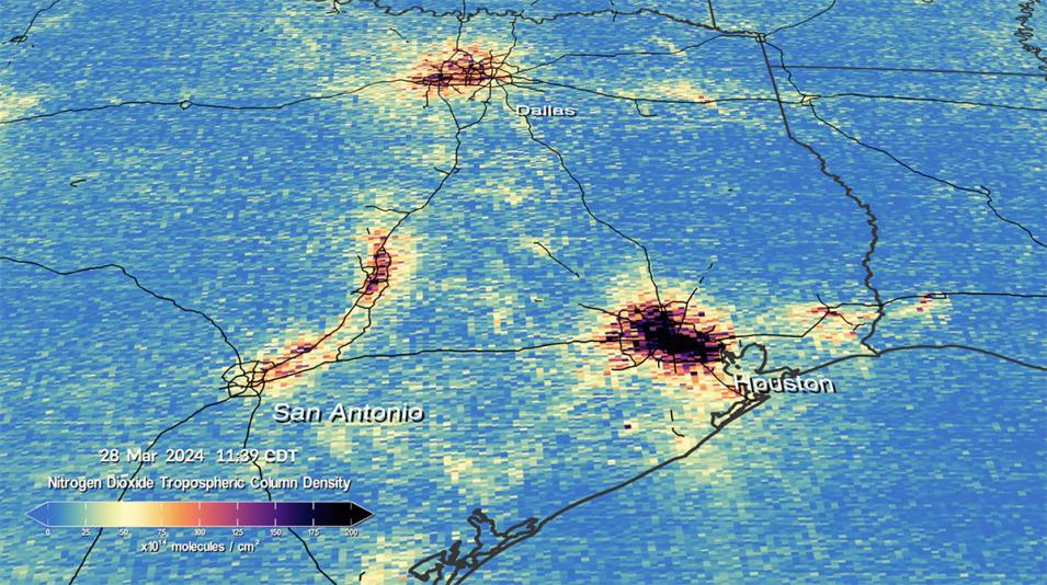 This is a rectangular image of Eastern Texas showing nitrogen dioxide gas levels in the area. Most of the image is colored blue indicating lower levels of gas. The lower left of the image shows San Antonio colored in shades of yellow, orange, and red to indicate moderate levels of gas. In the upper middle is Dallas colored in orange, red, and black indicating increasingly higher levels of gas. In the lower left is Houston, also colored in orange, red, and black indicating increasingly higher levels of gas.