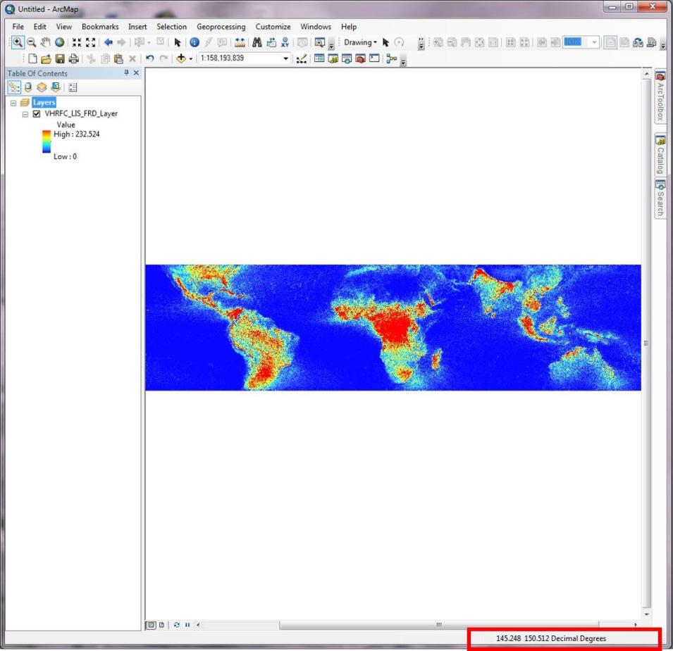 A window showing the resultant raster layer of a wide world map using a red to blue color ramp. In the bottom right hand corner a red box highlights the decimal degrees.