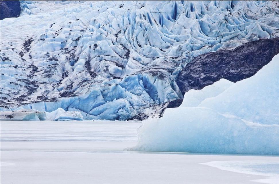 Ice and glaciers (blue) sit atop a frozen body of water (white).