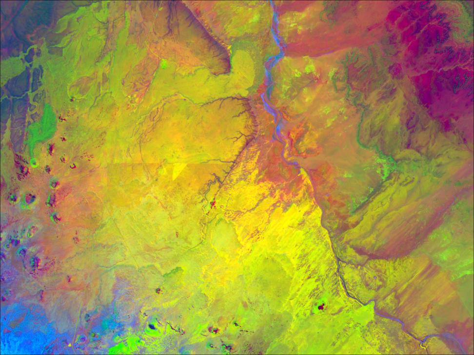 From the bottom left corner of this data visualization of the Wupatki Basin, Arizona, bright blue swirls merge into light greens and yellows, progressing to bright pink in the top right corner.