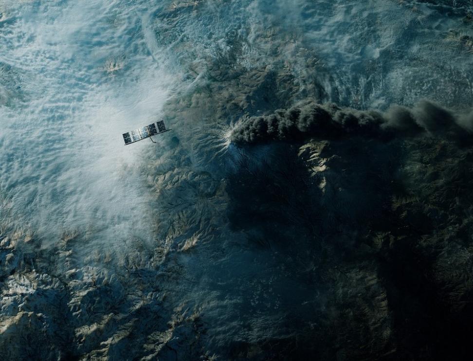 ICEYE satellite in orbit over an erupting volcano.