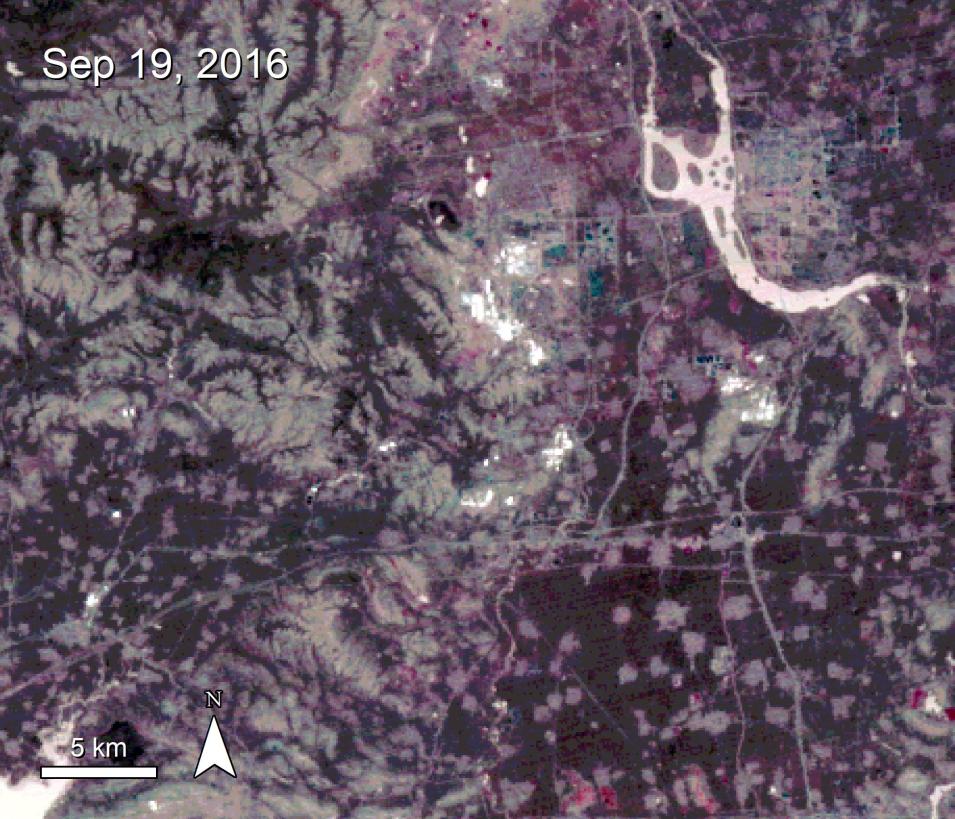 Features in this image of Tangshan, China, are colored in shades of black, gray, red, and white. Small areas in white scattered around the image indicate sources of heat. In the upper left-hand corner is the text Sep 19, 2016. 