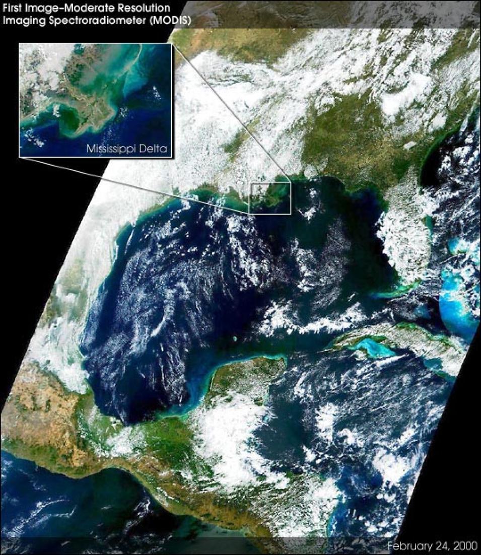 This image shows the Gulf of America in blue at the center of the scene with the Southern United States at the top and mostly clouded over. On the left side and bottom portion of the image are Mexico and Central America colored brown and green with some clouds. The right side of the image shows Cuba and the Carribbean Islands. In the upper left of the image is a zoomed-in thumbnail image of the New Orleans area.