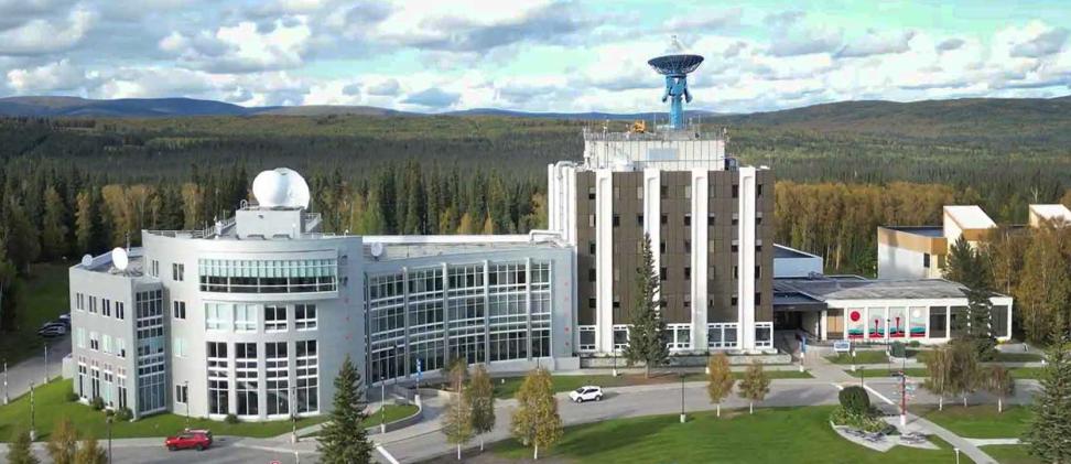 View from above of the ASF and Geophysical Institute offices in the Elvey building on the University of Alaska Fairbanks campus surrounded by forests and vast landscape of the high North