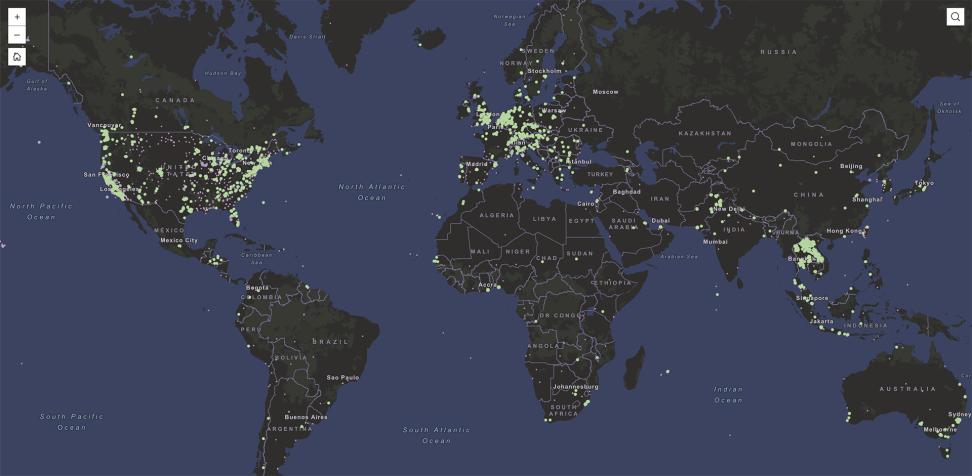 This map of the worlds shows the ocean colored in blue and land in shades of green. Hundreds of green dots are plotted across the land to show the locations of air quality sensors.