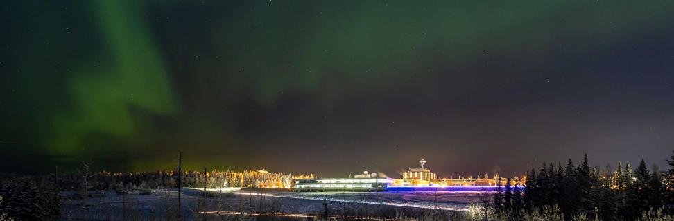 View of the Geophysical Institute and ASF office building against a night sky with the Northern Lights