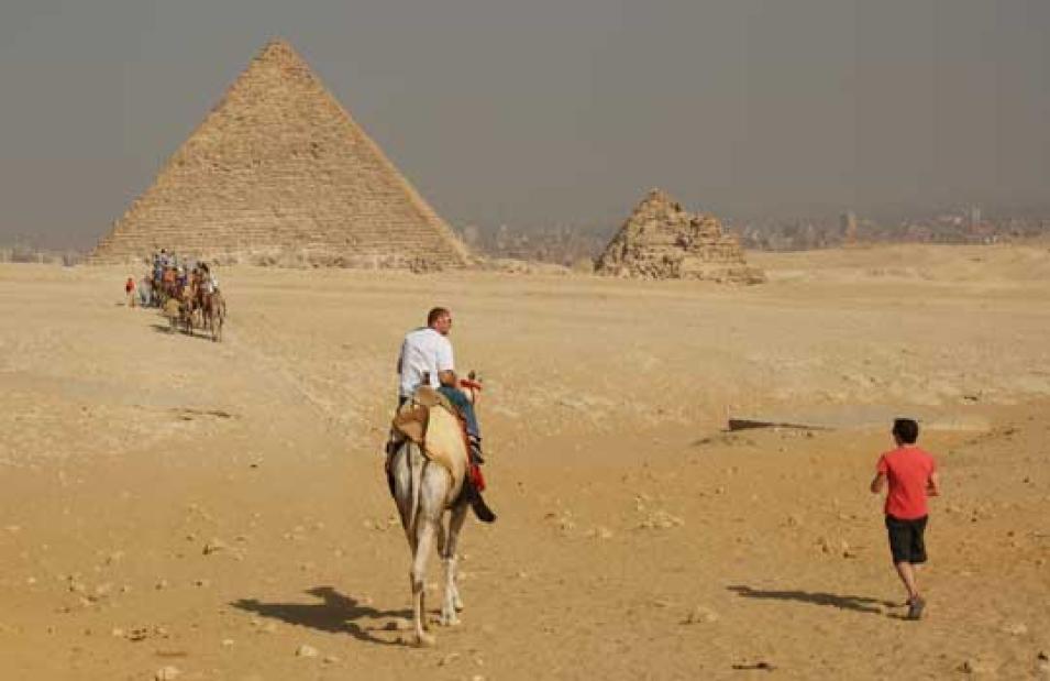 Photograph of people approaching smog-blanketed Cairo