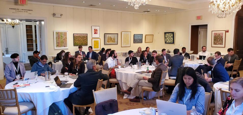 Participants of the machine learning workshop are shown sitting around tables.