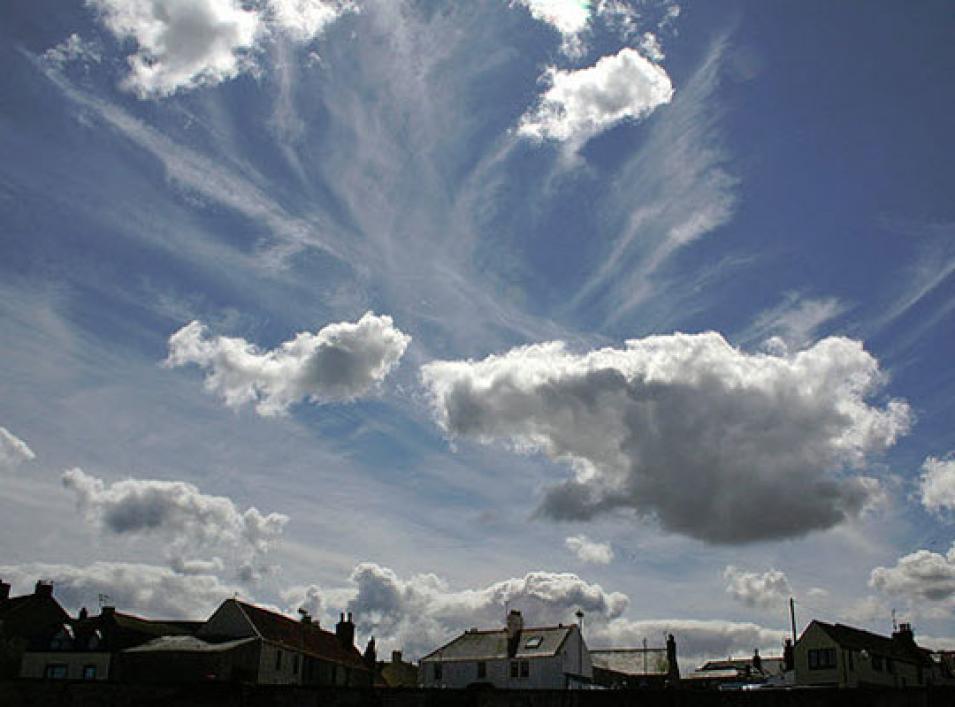 High, cold cirrus and lower, puffy cumulus clouds