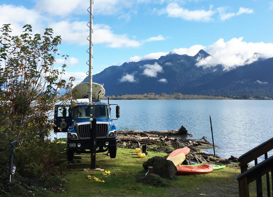 Photograph of a Doppler weather radar situated on a truck near a lake