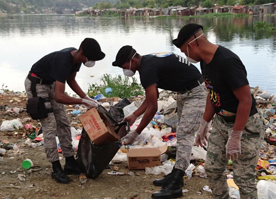 Photograph of workers picking up trash