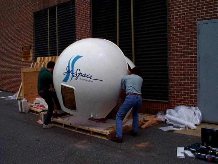 Burt and Gene haul the radome into position