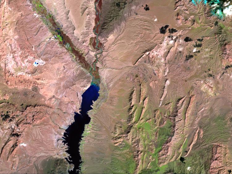 he south of the scene includes Lake Mead, a reservoir formed by the Hoover Dam on the Colorado River. 