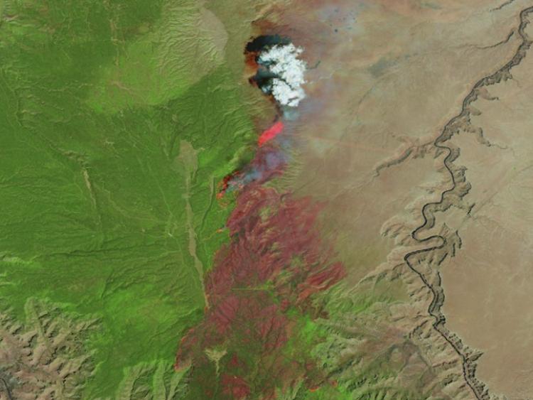 Satellite imagery showing burned area and active fire fronts from the Dragon Bravo fire.