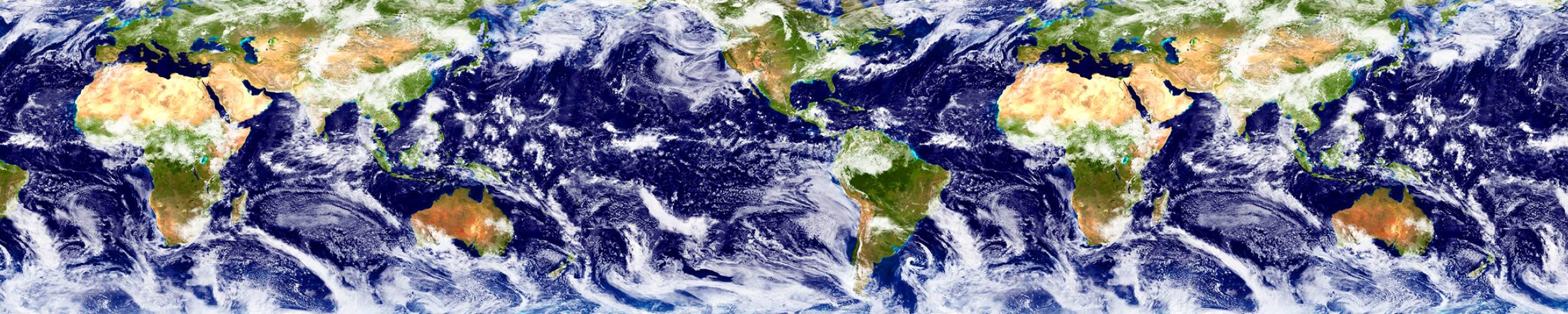 A satellite image of Earth shows land in shades of green and water in shades of blue, with swirling white clouds. 