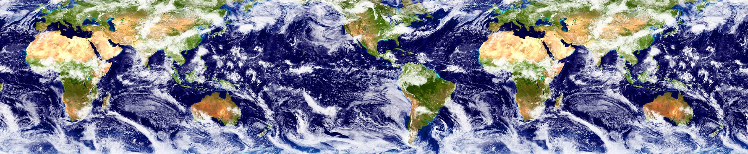 A satellite image of Earth shows land in shades of green and water in shades of blue, with swirling white clouds. 