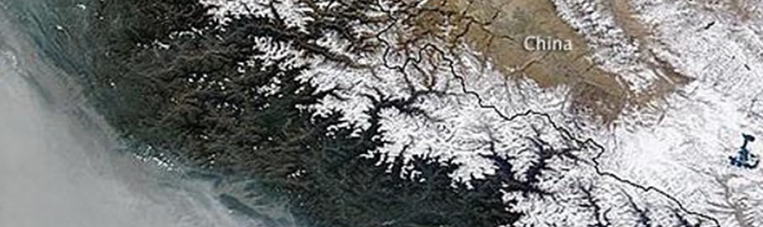 This satellite image from NASA shows a thick blanket of haze, or air pollution, covering the Indo-Gangetic Plain of northern India and Nepal, pressed against the foothills of the Himalayas