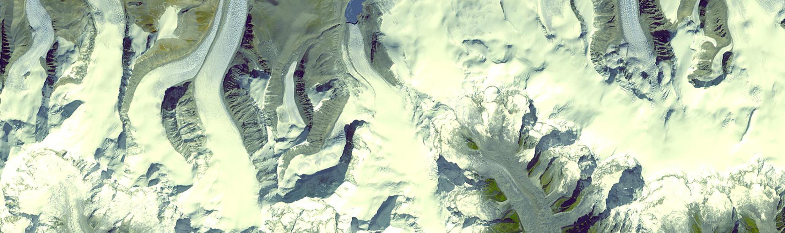 This image is a satellite view of the Himalayan glaciers in Bhutan, featuring numerous glacial lakes formed from melting ice. 