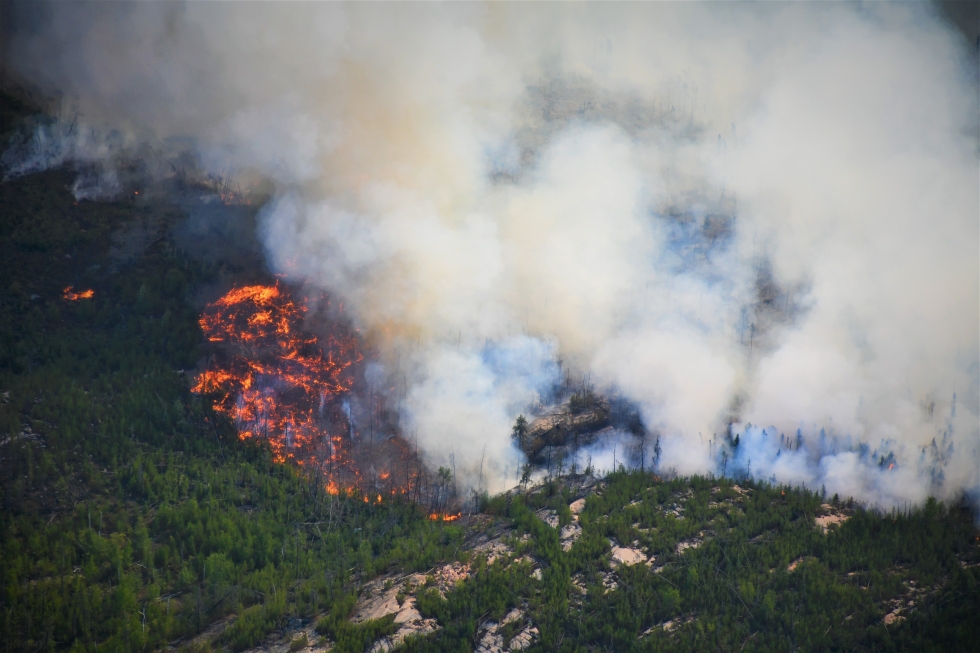 An aerial image of a fire burning in the boreal forest and Canadian Shield in the South Slave Region of the Northwest Territories.