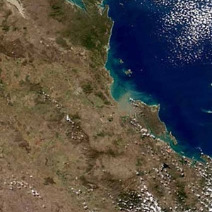 This MODIS image from July 19, 2006, shows muddy water from the rangeland-dominated Fitzroy River catchment entering the waters near the Great Barrier Reef,