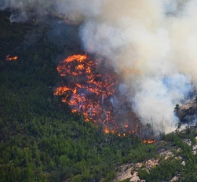 This aerial image shows a fire burning in a forest in Canada's Northwest Territories