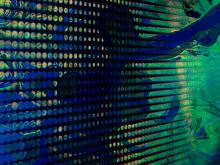 Swirling blues, greens, and yellows evoke imagery of Earth data.